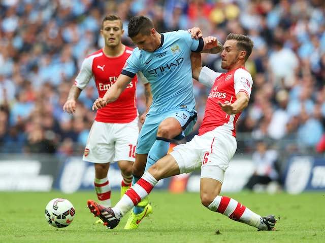 Jack Wilshere and Aaron Ramsey take on Stevan Jovetic during the Community Shield on August 10, 2014