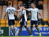 Kemar Roofe (R) of West Bromwich Albion celebrates with team-mate Liam O'Neil after he scores the first goal of the game for his side during the Pre Season Friendly against Port Vale on August 5, 2014