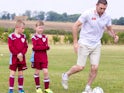 Martin Keown demonstrates how not to dribble in front of some unimpressed youngsters