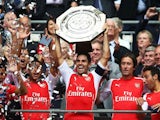 Mikel Arteta holds the Community Shield as Arsenal celebrate on August 10, 2014