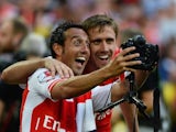 Arsenal teammates Santi Cazorla and Nacho Monreal pose for a selfie with an extremely large camera after winning the Community Shield on August 10, 2014