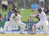 Sri Lankan cricketer Kaushal Silva is watched by Pakistan wicketkeeper Sarfraz Ahmed as he plays a shot during the second day of the opening Test match between Sri Lanka and Pakistan at the Galle International Cricket Stadium in Galle on August 7, 2014