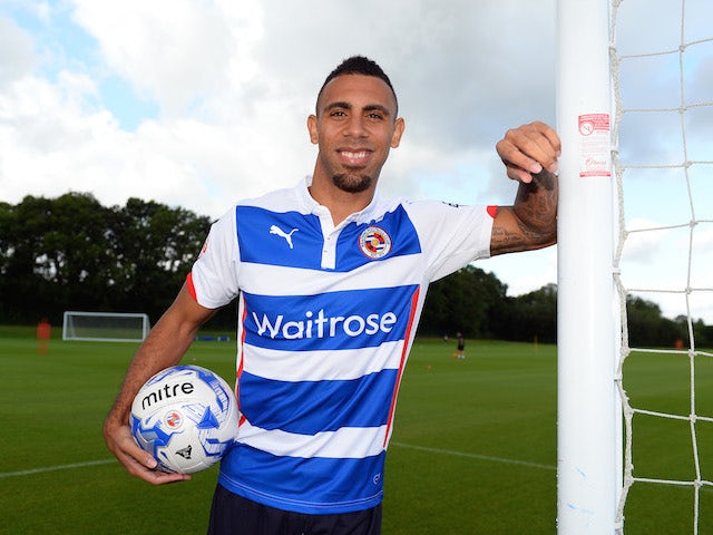 Anton Ferdinand poses in a Reading shirt after signing for the Royals on August 11, 2014