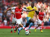 Mathieu Debuchy of Arsenal and Yannick Bolasie of Crystal Palace battle for the ball during the Barclays Premier League match between Arsenal and Crystal Palace at Emirates Stadium on August 16, 2014
