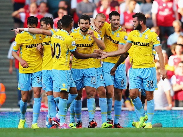 Crystal Palace players surround 'Big' Brede Hangeland after he scores their opener against Arsenal on August 16, 2014