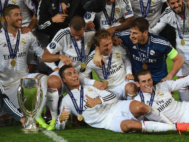 Real Madrid players Ronaldo (c) and Gareth Bale (r) celebrate with team mates and the trophy after the UEFA Super Cup match against Sevilla on August 12, 2014