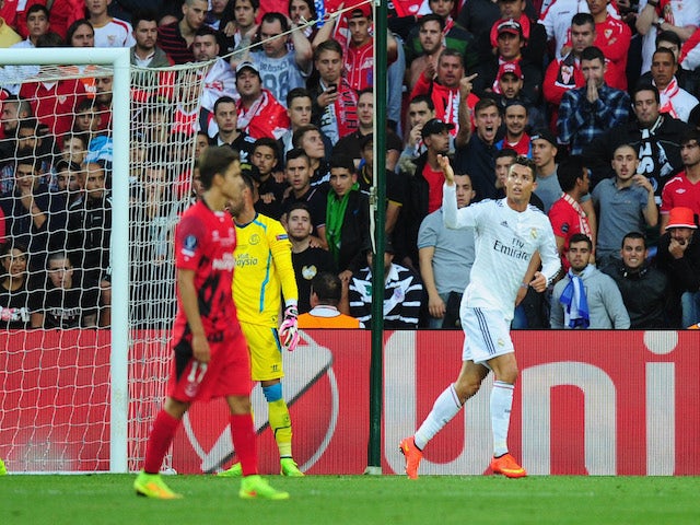 Real Madrid player Ronaldo (r) celebrates after scoring the opening goal during the UEFA Super Cup match between Real Madrid and Sevilla FC at Cardiff City Stadium on August 12, 2014