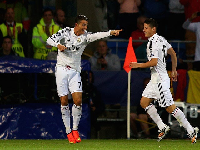 Cristiano Ronaldo of Real Madrid celebrates with teammate James Rodriguez after scoring their team's second goal during the UEFA Super Cup against Sevilla on August 12, 2014
