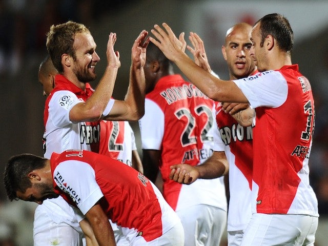 Monaco's forward Dimitar Berbatov (R) celebrates with teammates after scoring a goal during the French L1 football match between Bordeaux (FCGB) and Monaco (ASM) on August 17, 2014