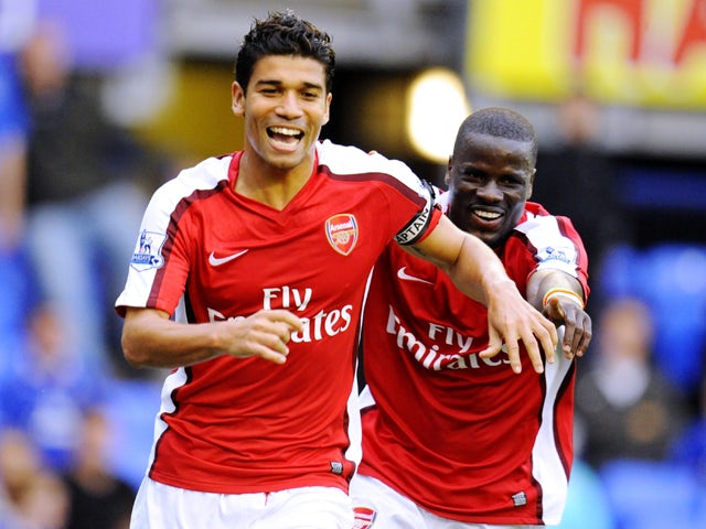 Eduardo Da Silva of Arsenal celebrates with teammate Emmanuel Eboue after scoring his team's sixth goal during the Barclays Premier League match between Everton and Arsenal at Goodison Park on August 15, 2009