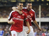 Francesc Fabregas of Arsenal is congratulated by teammate Robin van Persie (R) after scoring his team's fourth goal during the Barclays Premier League match between Everton and Arsenal at Goodison Park on August 15, 2009
