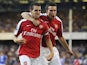 Francesc Fabregas of Arsenal is congratulated by teammate Robin van Persie (R) after scoring his team's fourth goal during the Barclays Premier League match between Everton and Arsenal at Goodison Park on August 15, 2009