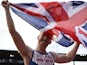 Great Britain's Greg Rutherford, holding his national flag, celebrates after winning the Men's Long Jump final during the European Athletics Championships at the Letzigrund stadium in Zurich on August 17, 2014