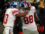 Hakeem Nicks #88 of the New York Giants celebrates with teammate Victor Cruz #80 after a 66 yard touchdown catch against the Green Bay Packers on January 15, 2012