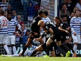 James Chester #5 of Hull City is congratulated by teammates after scoring the opening goal during the Barclays Premier League match between Queens Park Rangers and Hull City at Loftus Road on August 16, 2014