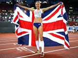 Jo Pavey of Great Britain and Northern Ireland poses with a Union Jack after winning gold in the Women's 10,000 metres final on August 12, 2014