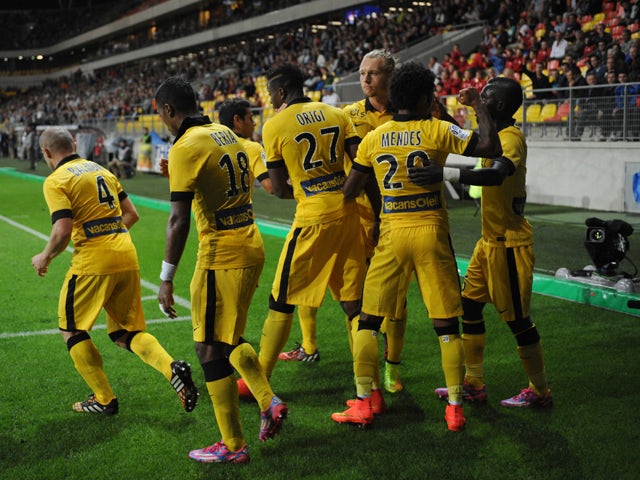 Lille's Belgian Forward Divock Origi celebrates with teammates after scoring a penalty during the French L1 football match between Caen (SM Caen) and Lille (LOSC) on August 15, 2014