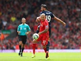 Martin Skrtel of Liverpool challenges Graziano Pelle of Southampton during the Barclays Premier League match between Liverpool and Southampton at Anfield on August 17, 2014