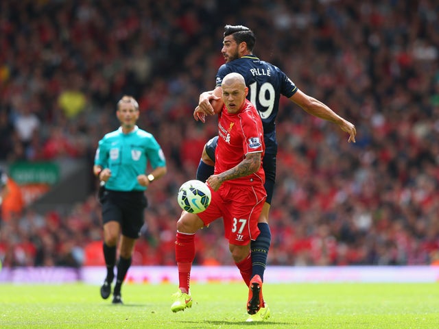 Martin Skrtel of Liverpool challenges Graziano Pelle of Southampton during the Barclays Premier League match between Liverpool and Southampton at Anfield on August 17, 2014