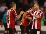 Marc McNulty of Sheffield United celebrates scoring his teams winning goal with team mate Ben Davies during the Capital One Cup First Round match between Sheffield United and Mansfield Town at Bramell Lane on August 13, 2014