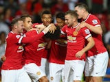Marouane Fellaini of Manchester United is congratulated by team mates after scoring the winning goal in the last minute during the Pre Season Friendly match against Valencia on August 12, 2014