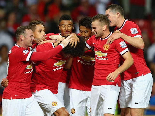 Marouane Fellaini of Manchester United is congratulated by team mates after scoring the winning goal in the last minute during the Pre Season Friendly match against Valencia on August 12, 2014