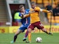 Liam Polworth of Inverness vies with Keith Lasley of Motherwell during the Scottish Premiership League Match between Motherwell and Inverness Caledonian Thistle at Fir Park on August 16, 2014
