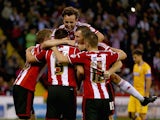 Andy Butler of Sheffield United celebrates with his team mates after scoring his teams first goal during the Capital One Cup First Round match between Sheffield United and Mansfield Town at Bramell Lane on August 13, 2014 