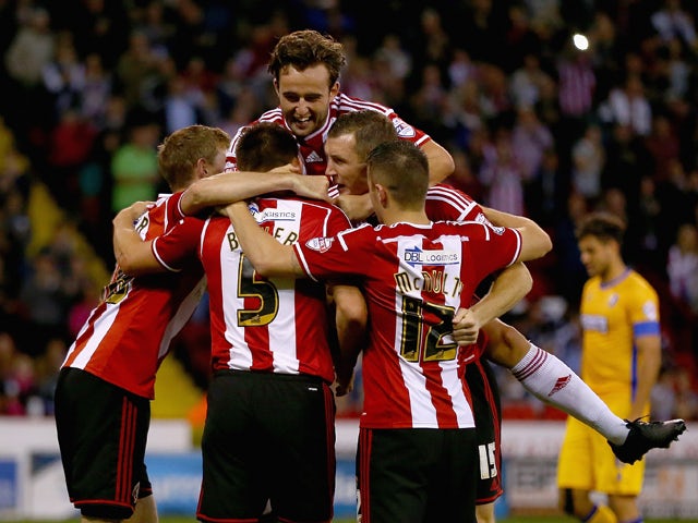 Andy Butler of Sheffield United celebrates with his team mates after scoring his teams first goal during the Capital One Cup First Round match between Sheffield United and Mansfield Town at Bramell Lane on August 13, 2014 