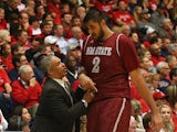 Head coach Marvin Menzies of the New Mexico State Aggies talks with Sim Bhullar #2 during the college basketball game against the Arizona Wildcats at McKale Center on December 11, 2013
