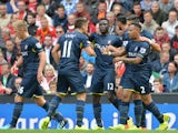 Southampton's English defender Nathaniel Clyne clebrates scoring the equalising goal with teammates during the English Premier League football match between Liverpool and Southampton at Anfield stadium in Liverpool, northwest England, on August 17, 2014