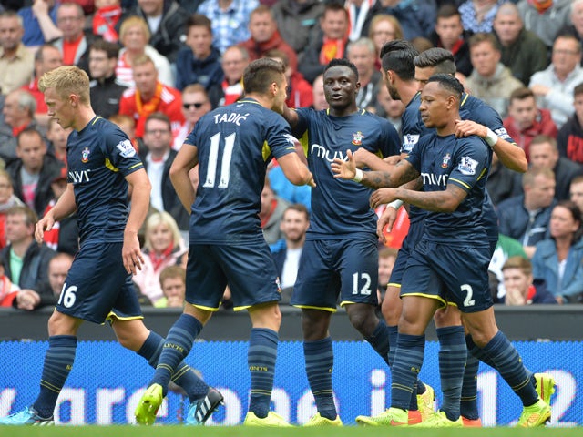 Southampton's English defender Nathaniel Clyne clebrates scoring the equalising goal with teammates during the English Premier League football match between Liverpool and Southampton at Anfield stadium in Liverpool, northwest England, on August 17, 2014