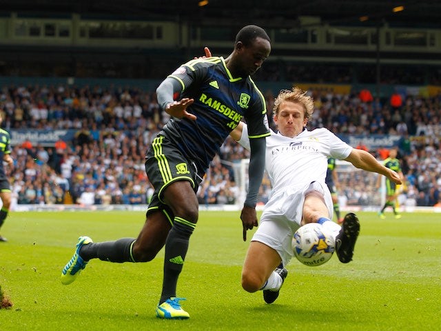 Leeds's Stephen Warnock slides in to take the ball from Albert Adomah of Middlesbrough on August 16, 2014