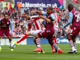 Gabriel Agbonlahor of Aston Villa in action with Marc Wilson of Stoke City during the Barclays Premier League match between Stoke City and Aston Villa at Britannia Stadium on August 16, 2014 