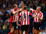 Lee Cattermole of Sunderland celebrates scoring the opening goal with John O'Shea and Jack Rodwell of Sunderland during the Barclays Premier League match between West Bromwich Albion and Sunderland at The Hawthorns on August 16, 2014