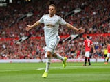 Gylfi Sigurdsson of Swansea City celebrates scoring his team's second goal during the Barclays Premier League match between Manchester United and Swansea City at Old Trafford on August 16, 2014