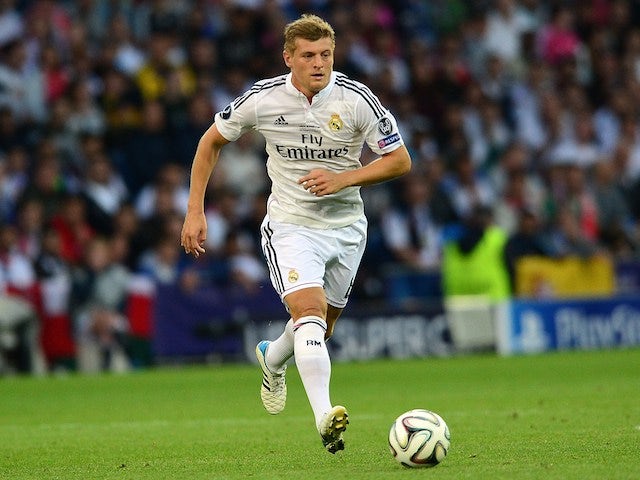 Real Madrids German midfielder Toni Kroos runs with the ball during the UEFA Super Cup football match between Real Madrid and Sevilla at Cardiff City Stadium in Cardiff, south Wales on August 12, 2014
