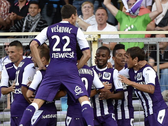 Toulouse's French-Ivorian defender Jean Akpa-Akpro celebrates with teammates after scoring a goal during the French L1 football match between Toulouse (TFC) and Lyon (OL) on August 16, 2014
