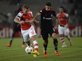 Besiktas's Ismail Koybasi fights for the ball with Arsenal's Jack Wilshere during their UEFA Champions League play-off first leg football match at the Ataturk Olympic Stadium in Istanbul, on August 19, 2014
