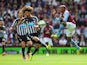 Fabian Delph of Aston Villa challenges Fabricio Coloccini of Newcastle United during the Barclays Premier League match between Aston Villa and Newcastle United at Villa Park on August 23, 2014