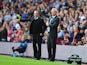 Manager Paul Lambert of Aston Villa gives instructions with Alan Pardew, manager of Newcastle United during the Barclays Premier League match between Aston Villa and Newcastle United at Villa Park on August 23, 2014