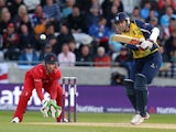Rikki Clarke of Birmingham Bears drives at the ball with Jos Buttler of Lancashire Lightning looking on during the Natwest T20 Blast Final match between Birmingham Bears and Lancashire Lightning at Edgbaston on August 23, 2014