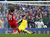 Thibaut Courtois of Chelsea saves from David Nugent of Leicester City during the Barclays Premier League match between Chelsea and Leicester City at Stamford Bridge on August 23, 2014