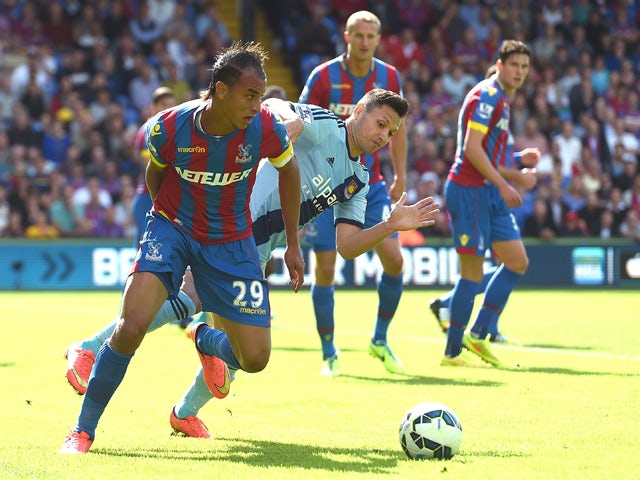 Marouane Chamakh of Crystal Palace and Mauro Zarate of West Ham in action during the Premiere League match between Crystal Palace and West Ham United at Selhurst Park on August 23, 2014