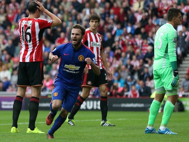 Manchester United's Spanish midfielder Juan Mata (2nd L) celebrates scoring the opening goal of the English Premier League football match against Sunderland on August 24, 2014