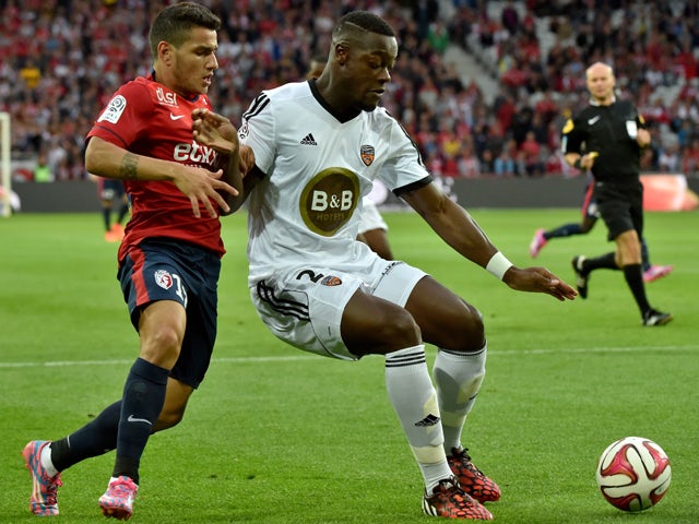 Lorient's French Ivorian defender Lamine Kone vies with Lille's Portuguese midfielder Marco Lopes during the French L1 football match Lille (LOSC) vs Lorient (FCL) on August 23, 2014