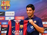 Luis Suarez poses for the media during a press conference as part of his presentation as a new FC Barcelona player at Camp Nou on August 19, 2014