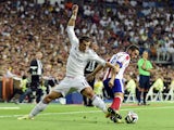 Real Madrid's Welsh forward Gareth Bale vies with Atletico Madrid's midfielder Koke during the Spanish Supercup first-leg football match Real Madrid CF vs Club Atletico de Madrid at the Santiago Bernabeu stadium in Madrid on August 19, 2014