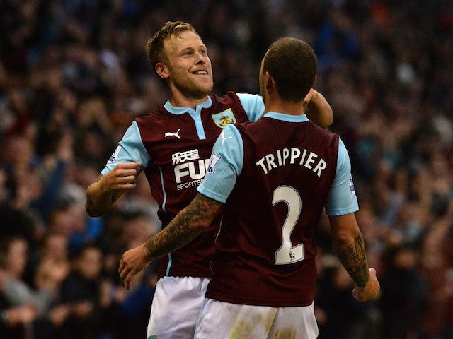 Burnley's Scottish midfielder Scott Arfield (L) celebrates with Burnley's English defender Kieran Trippier (R) after scoring the opening goal of the English Premier League football match against Chelsea on August 18, 2014