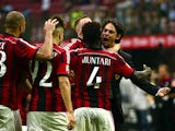 AC Milan's midfielder of Ghana Sulley Ali Muntari celebrates with AC Milan's coach Filippo Inzaghi after scoring during the Serie A football match AC Milan against Lazio on August 31, 2014